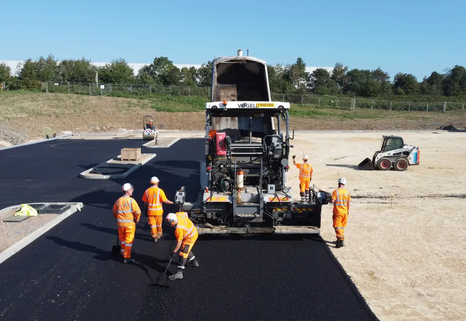workers walking along with a paver in Lutterworth England