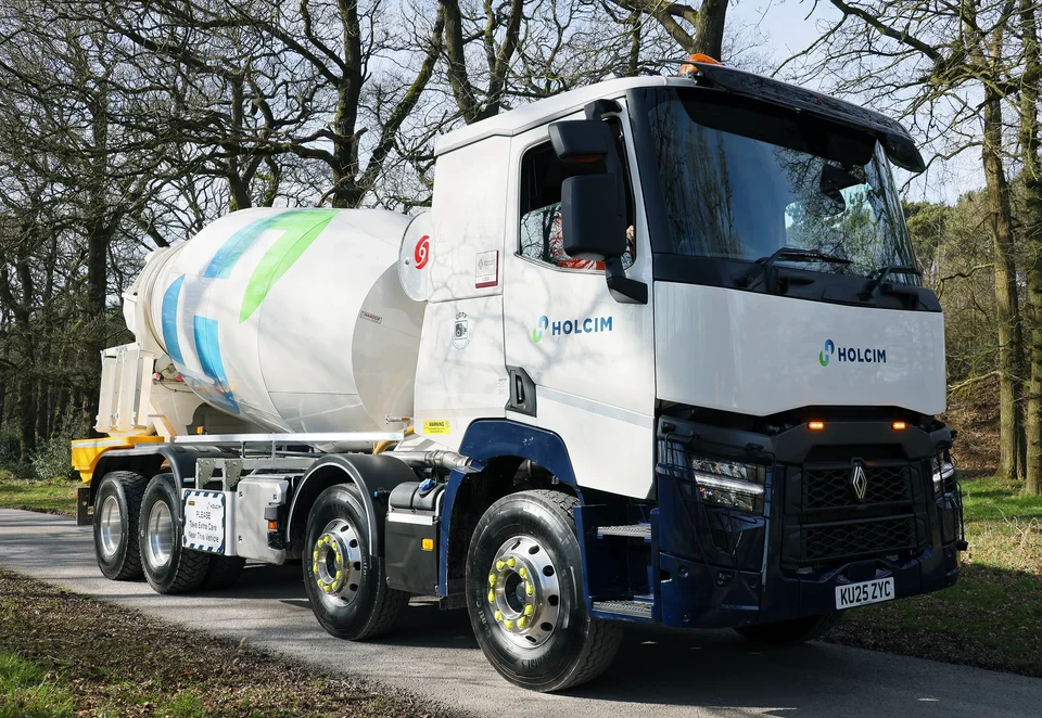 Holcim UK ready-mix concrete mixer truck featuring green and blue corporate branding.