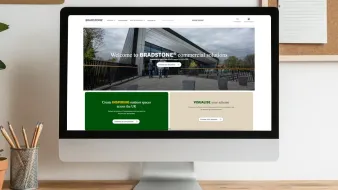 office desk with a computer monitor that's displaying the Bradstone Commercial web page