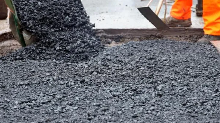 Asphalt being laid on a utilities job.jpg