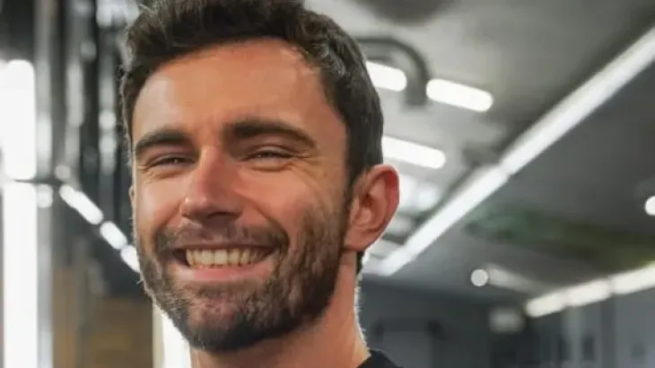 Man smiling inside a building