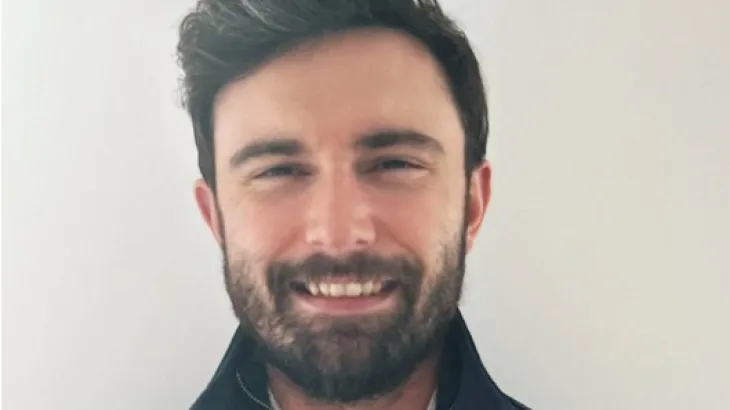 Man wearing a jumper with the Holcim logo