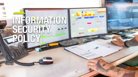 Information Security Policy text over a person working on a computer