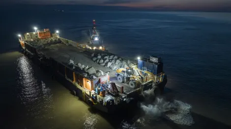 Rockarmour being delivered to the Blue Anchor coastline by the SeaRock barge at night