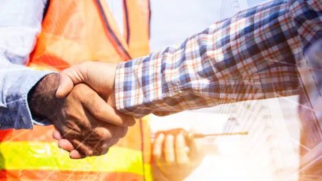 Contractor shaking hands in high vis