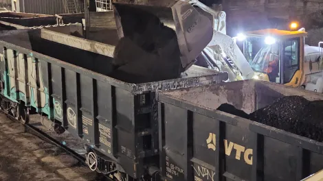 RAP (Reclaimed Asphalt Pavement) being loaded onto rail cars to be transferred to an Aggregate Industries site in London