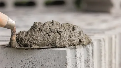 Cement on trowel placed on a concrete block