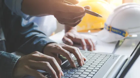 eTOTS Library construction workers at laptop
