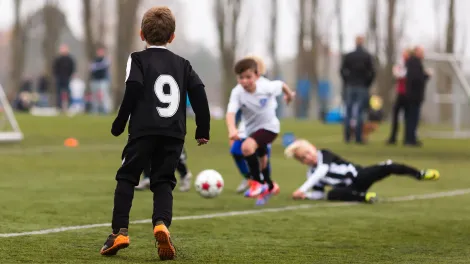 Children playing football outside