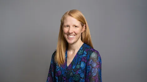 Lady in a professional photo wearing a blue dress