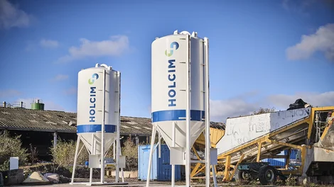 Two dry mortar silos with Holcim logo on the side