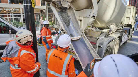 A biochar coffee concrete mix being poured at Canary Wharf