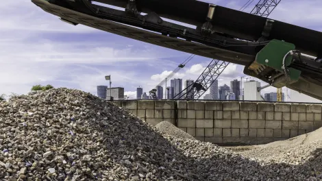 Aggregate mound with conveyor above and the London Skyline behind