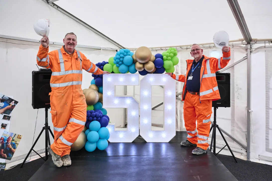 Ian "Speedy" White and Graham "Lou" Robinson raise their hard hats to 50 years service at Holcim UK's Bardon Hill Quarry