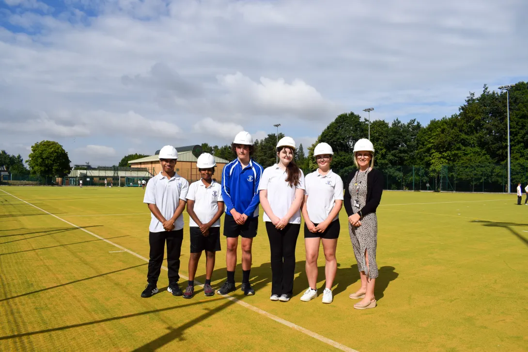 Headtecher Hazel Boyce and pupils at St Benedict School Derby on the newly refurbished sports pitch. Holcim donated specialist sports sands towards the project.