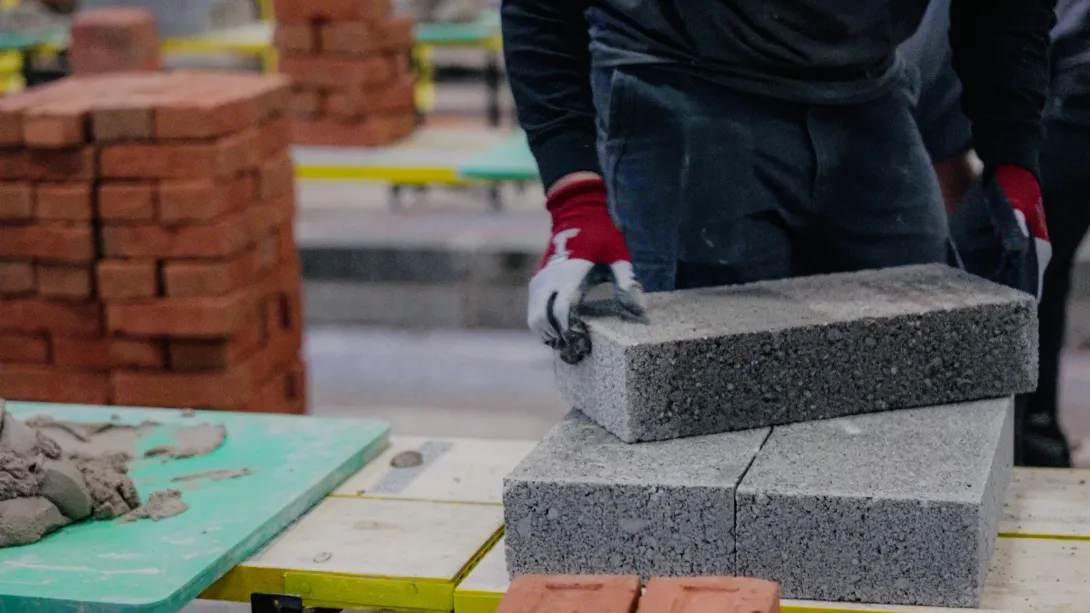 A contestant handling a Holcim block at a regional Super Trowel event. Holcim UK is one of the event sponsors.