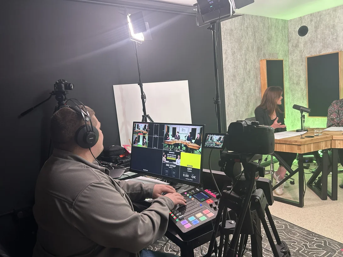 An enginner mixes the sound and vision on a mixing desk behind the scenes in the studio at Holcim's The Material Mix podcast.