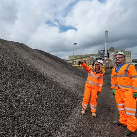 Aggregate pile with people in ppe