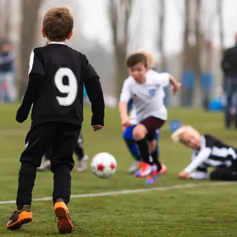 Children playing football outside